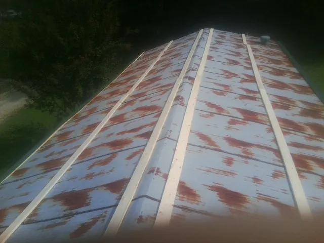 Rusted metal roof panels with new wood purlins before replacement — Storm Damage Roof Repair in Clearwater by Roofing Brothers